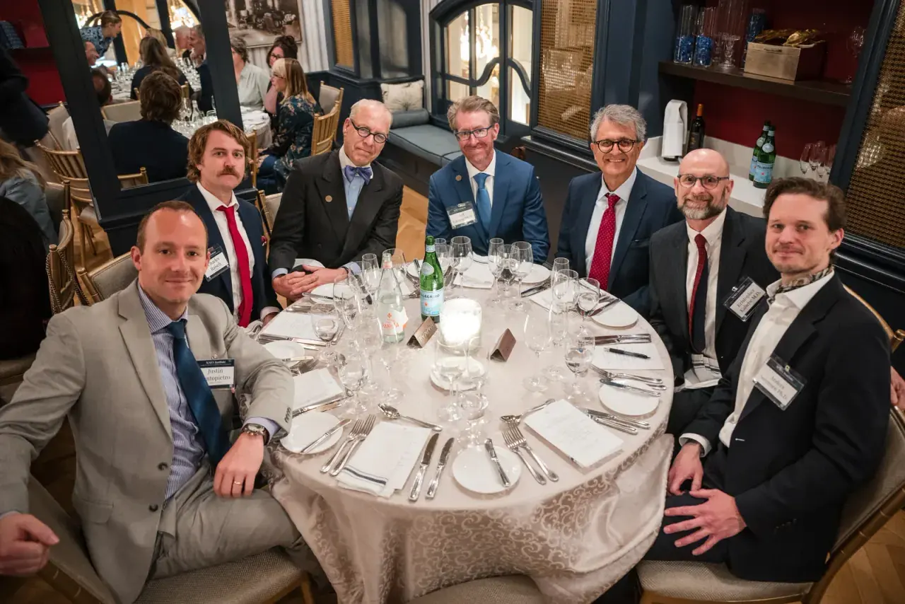 Attendees gathered around a table at a MAHA Institute summit dinner