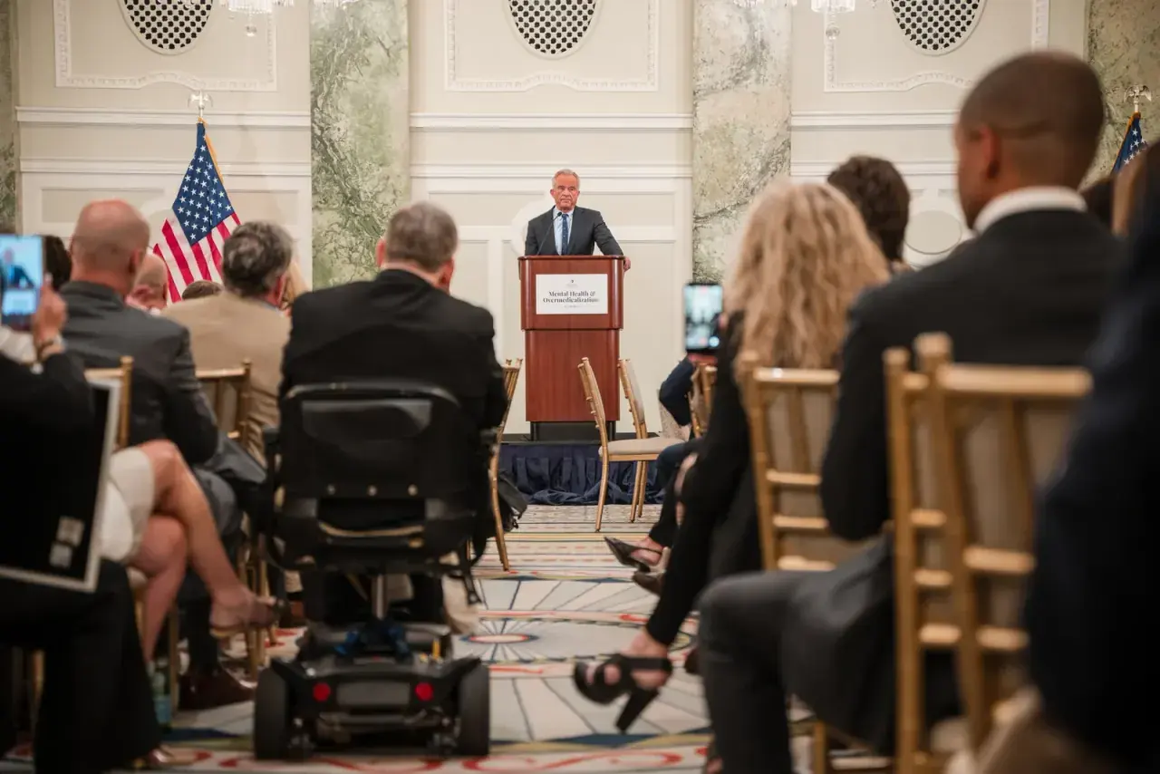 Speaker addressing a seated audience in the summit ballroom